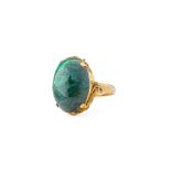 A 14ct gold and malachite dress ring, the 18 x 12mm. cabochon cut malachite held in a four pronged