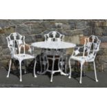 A cast metal Guernsey Lily garden table and three chairs, the table 35in. (88.9cm.) diameter, 27 ¼