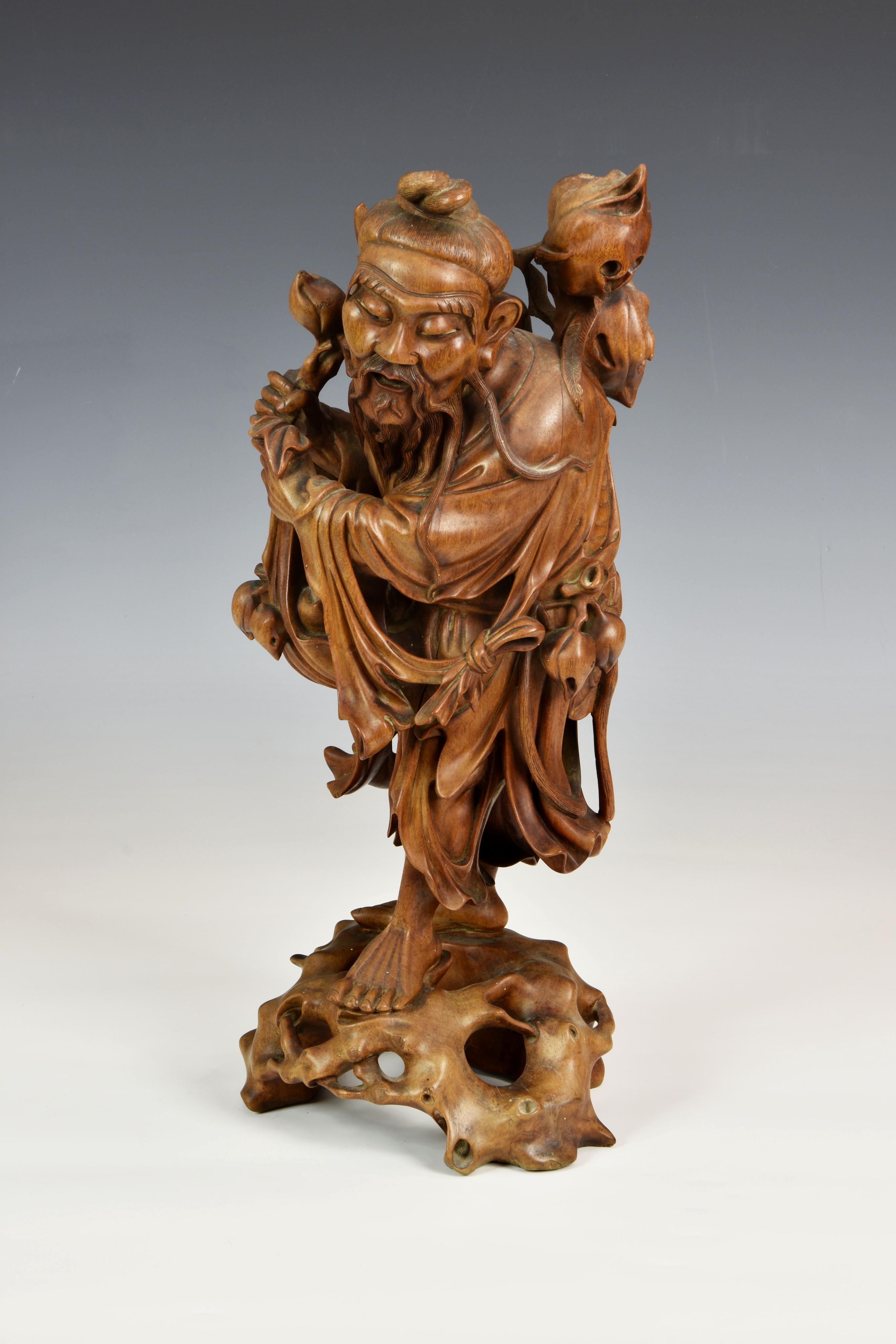 A Chinese carved boxwood figure of an immortal, late 18th / 19th century, the finely carved