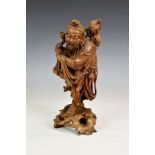 A Chinese carved boxwood figure of an immortal, late 18th / 19th century, the finely carved