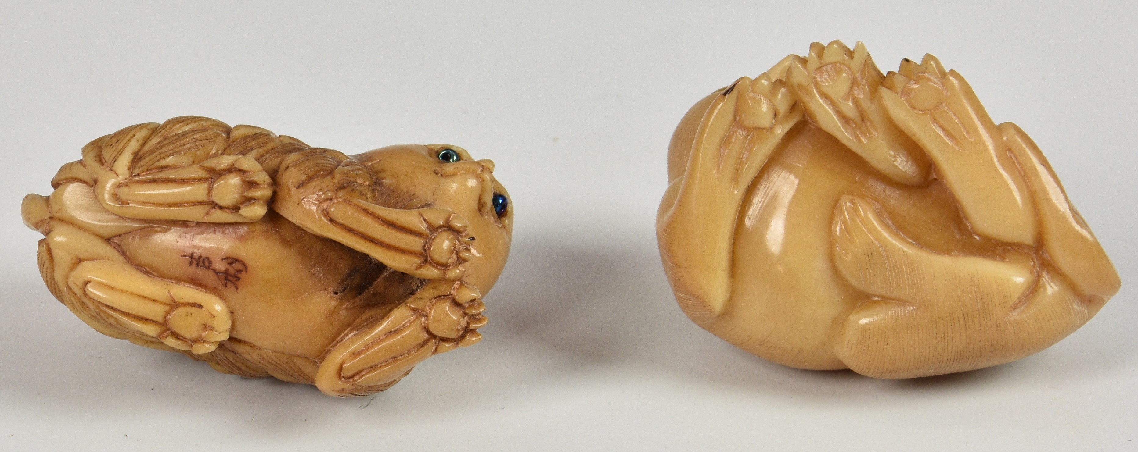 Two Japanese Tagua Nut Netsuke fashioned as cats, having glass eyes, both signed, 1 ¾in. (4.5cm.) - Image 3 of 3