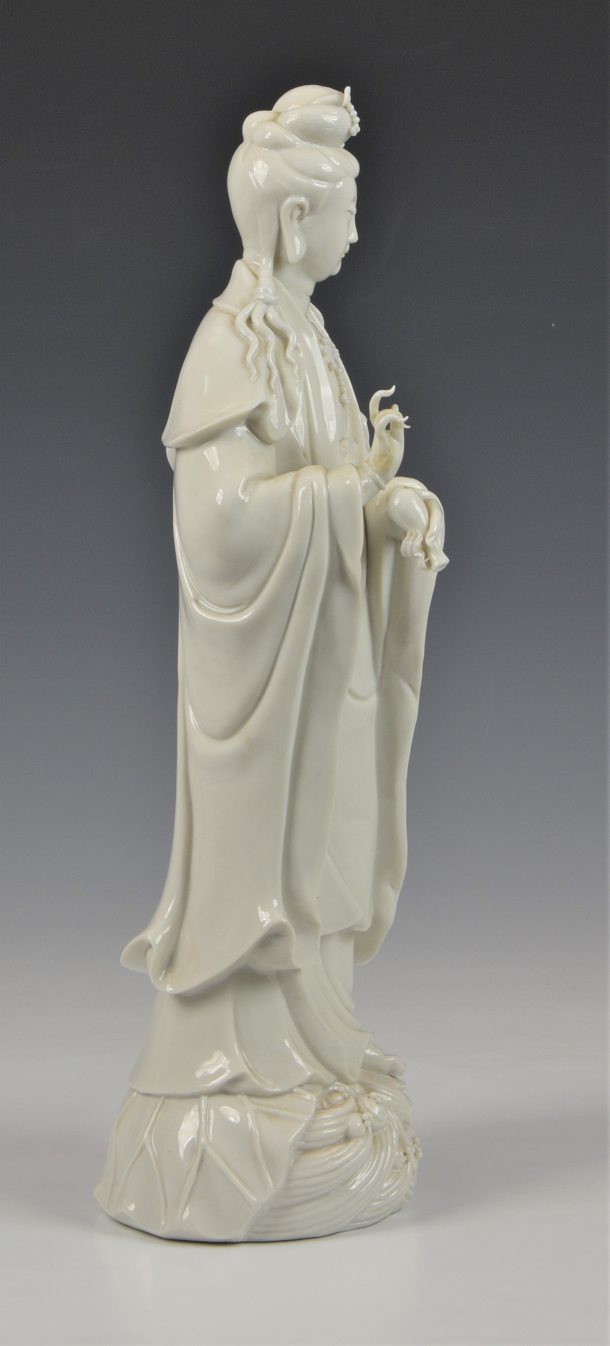 A Blanc de Chine figure of Guanyin, Continental, 20th century, figure holding a vase, standing on - Image 2 of 5