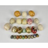 A collection of various Kashmiri and other decorated eggs, together with polished stone eggs. (