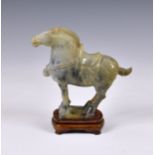 A Chinese carved green hardstone jade-style horse, modern, of typical Tang style, 7 ¾in. (19.7cm.)