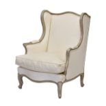 A French Louis XV style painted beech wood wing back armchair, probably 19th century, the serpentine