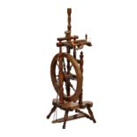 A late 19th / early 20th century beech wood, pine and yew spinning wheel, overall height 37in. (