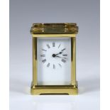 A late 19th century French brass carriage clock with leather travel case, the white enamel dial with