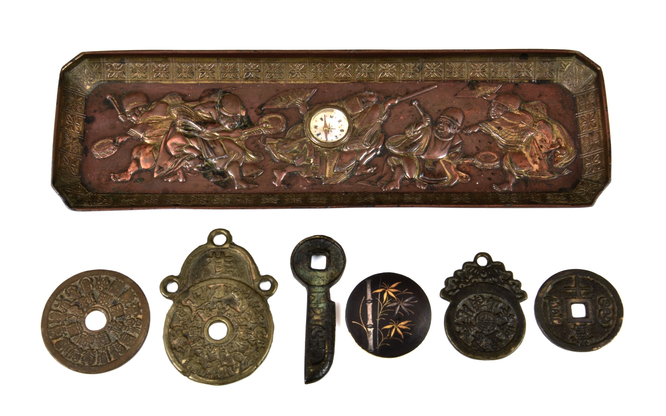 A Japanese metalwork Feng Shui tray with raised figures of minstrels, of rectangular form, centrally