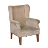 A George III style wingback armchair, early 20th century, with serpentine seat and square tapered