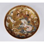 A Japanese Satsuma circular dish or charger, probably Meiji period (1868-1912), signed with large