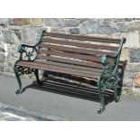 A 19th century style cast iron garden bench, painted green with hardwood slats, with lion mask and