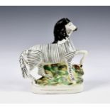 A 19th century Staffordshire pottery flatback Zebra, 8 ¾in. (22.25cm.) high. * Glaze cracks and