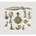 A collection of silver charms & a gold charm - page marker and medal, comprising of a 9ct gold