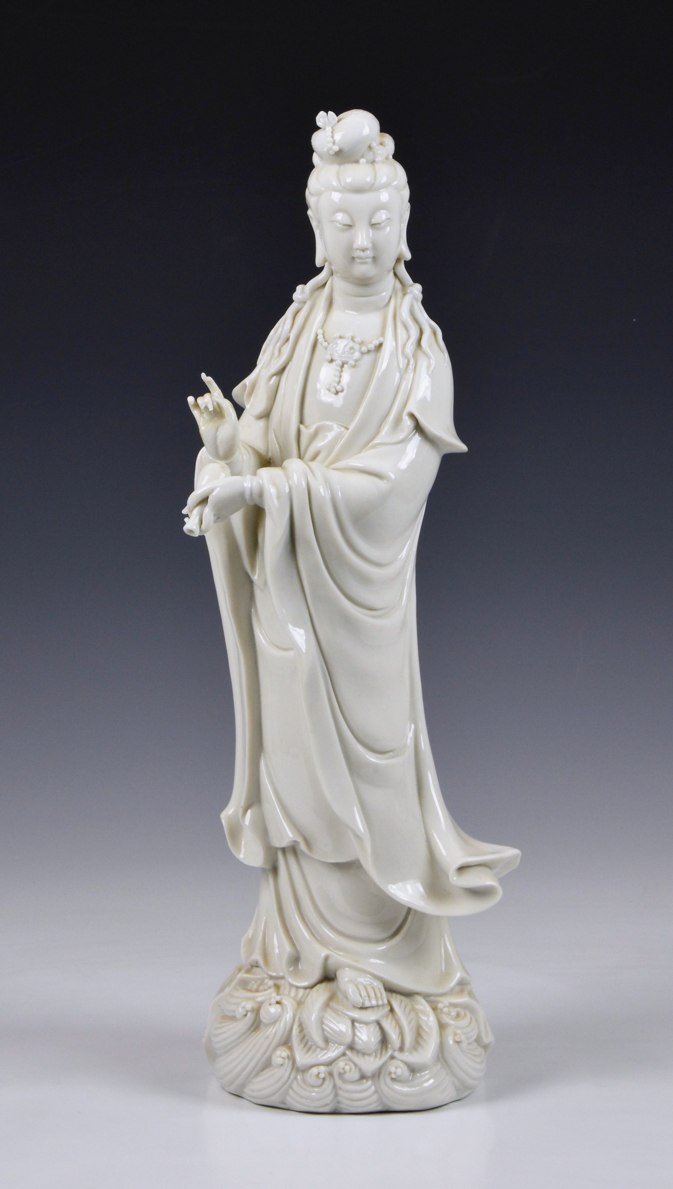 A Blanc de Chine figure of Guanyin, Continental, 20th century, figure holding a vase, standing on