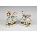 A pair of 19th century porcelain "Dancing Girls" spill vases, with blue beehive mark, probably Royal