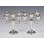 A pair of four branch silver candelabra, A T Cannon Ltd, Birmingham, 1975, ribbed branches, with