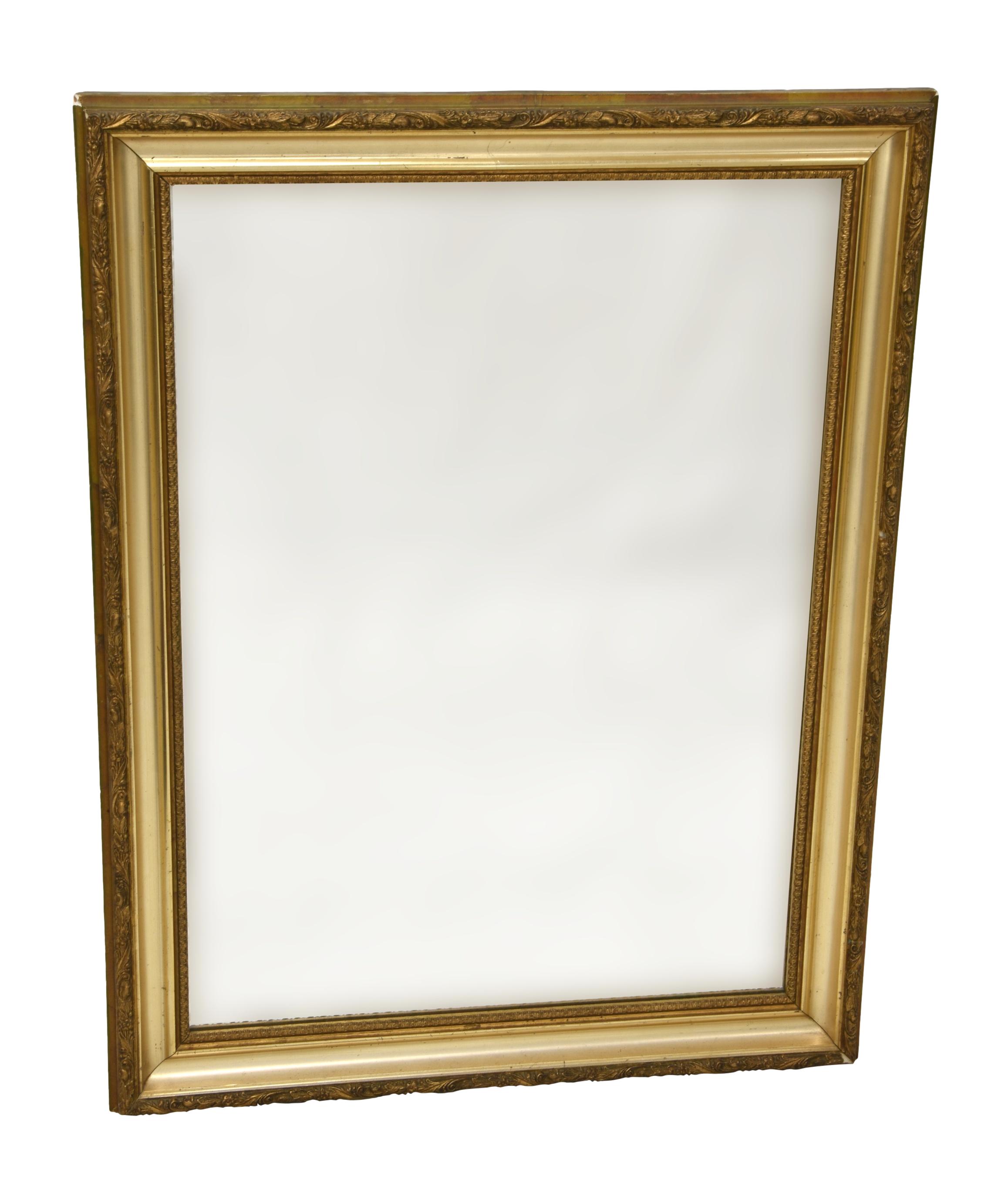 An Edwardian giltwood mirror, with foliate decorated hollow frame, 33½ x 25½in. (85 x 64.75cm.).