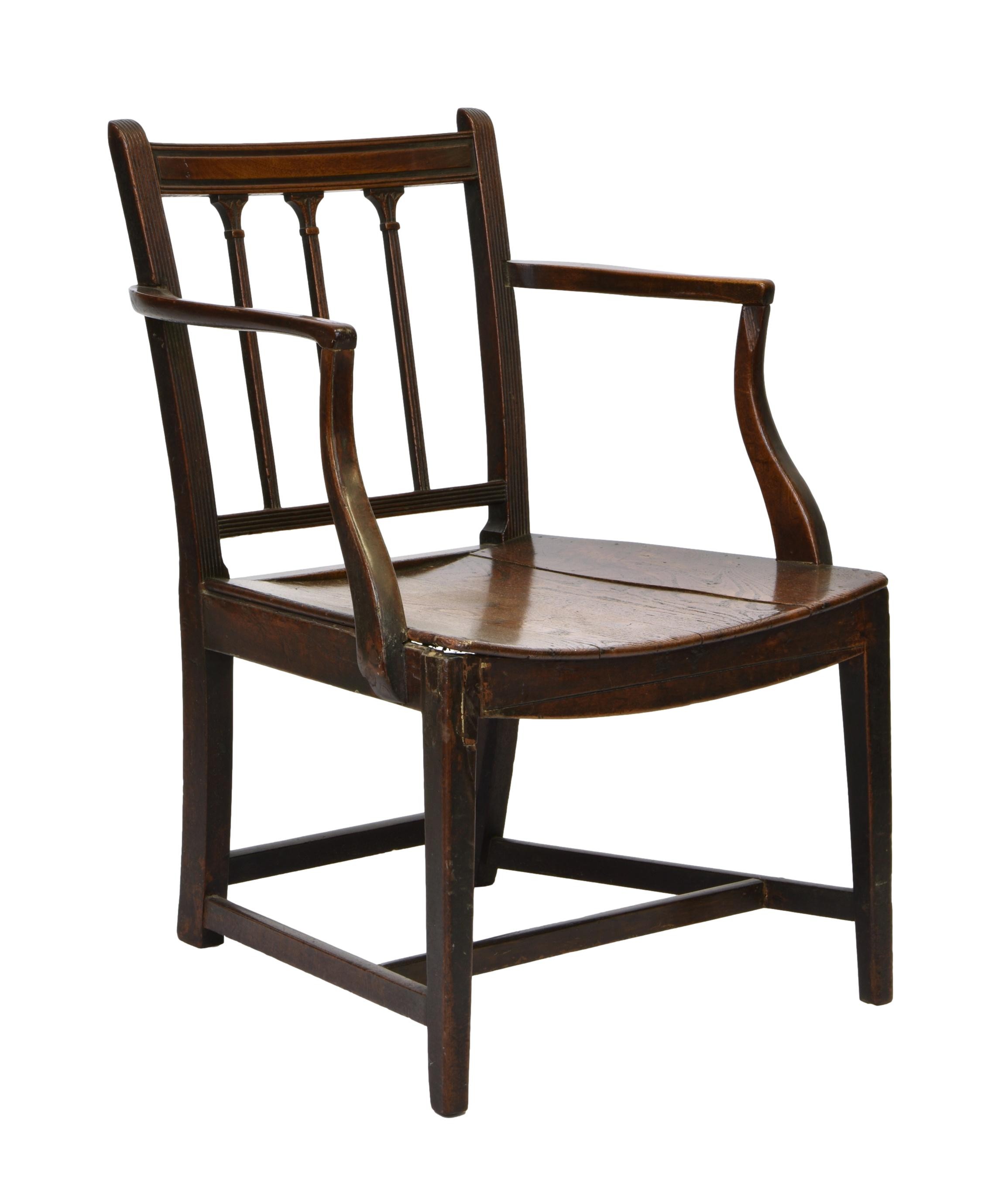 A George III provincial oak and mahogany elbow chair, the three bar back with reeded uprights and