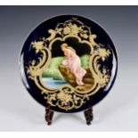 A 20th century Neoclassical style charger, the centre depicting a semi-nude maiden frolicking at