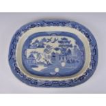 A large 19th century willow pattern meat platter, stamped 'EVANS & CLASSIN - SWANSEA', 22 5/8in. (
