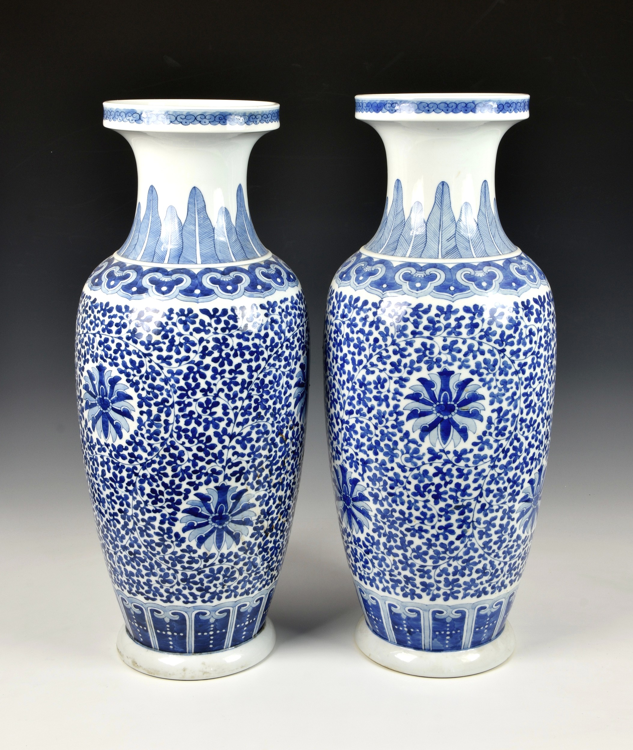 A pair of large Chinese blue and white lotus scroll baluster vases, 20th century, decorated with