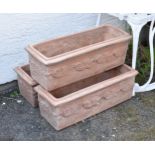 A set of three terracotta planters, of rectangular form, having moulded grapevine decoration, each