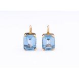 A pair of 9ct gold and blue spinel earrings, each set with a step-cut spinel measuring approx. 10