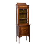 An Edwardian mahogany, satinwood cross banded and marquetry part-glazed cabinet, the short, shaped