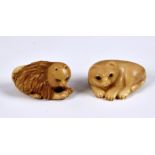 Two Japanese Tagua Nut Netsuke fashioned as cats, having glass eyes, both signed, 1 ¾in. (4.5cm.)