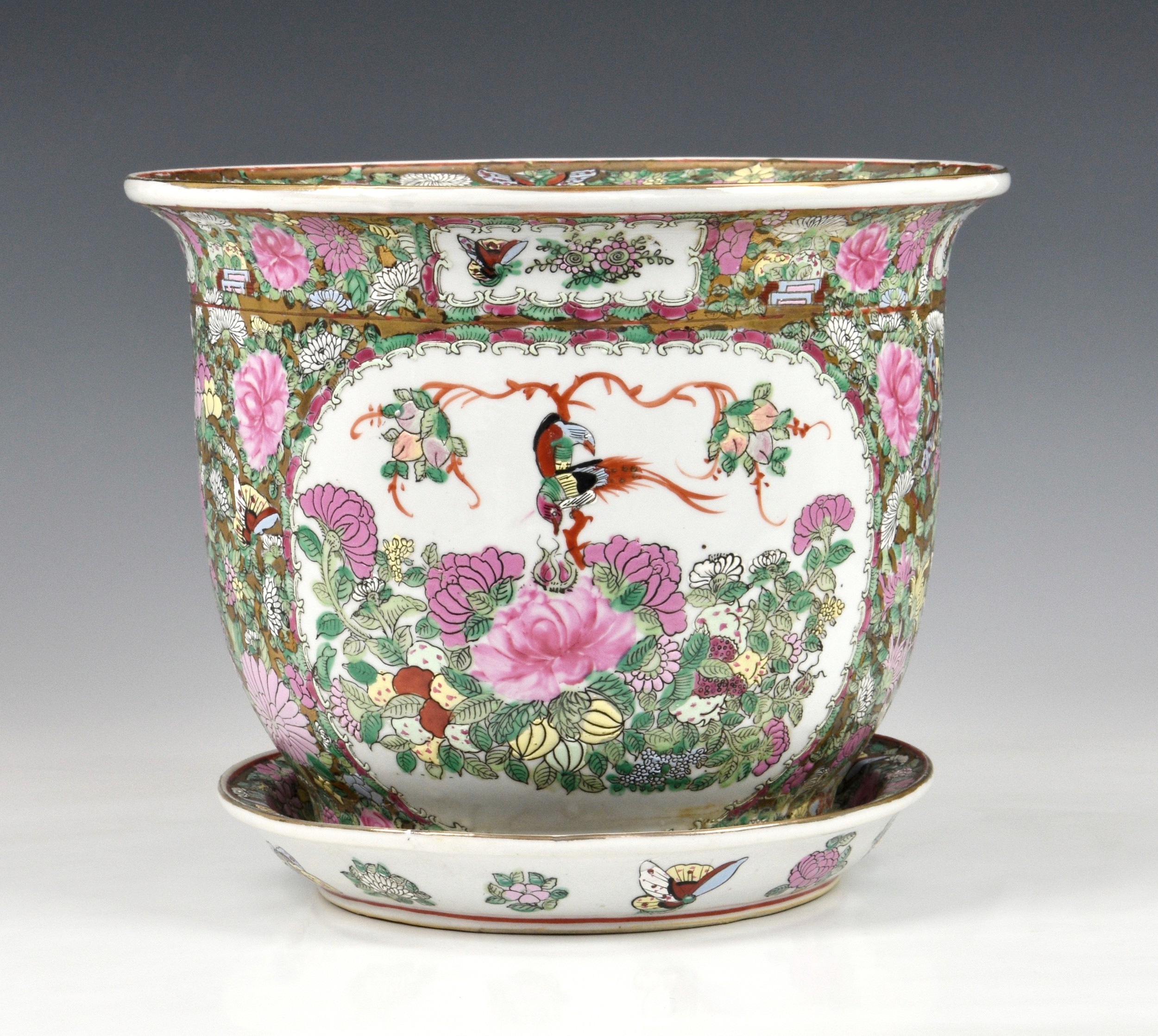 A Chinese famille rose jardiniere and saucer, 20th century, painted with two reserves with