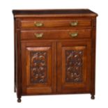 An Edwardian carved walnut side cabinet, the moulded top over two bevelled drawers with decorative