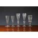 A pair of Georgian etched ale glasses, the trumpet bowls etched with hops and barley, on an