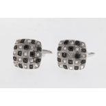 A pair of 18ct white gold and diamond cufflinks, featuring white and black diamonds in a