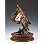 A Michael Sutty limited edition porcelain figure of St George, sword raised on his rearing horse, on