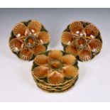 A set of six French Sarreguemines Majolica oyster plates, relief moulded with six oysters around