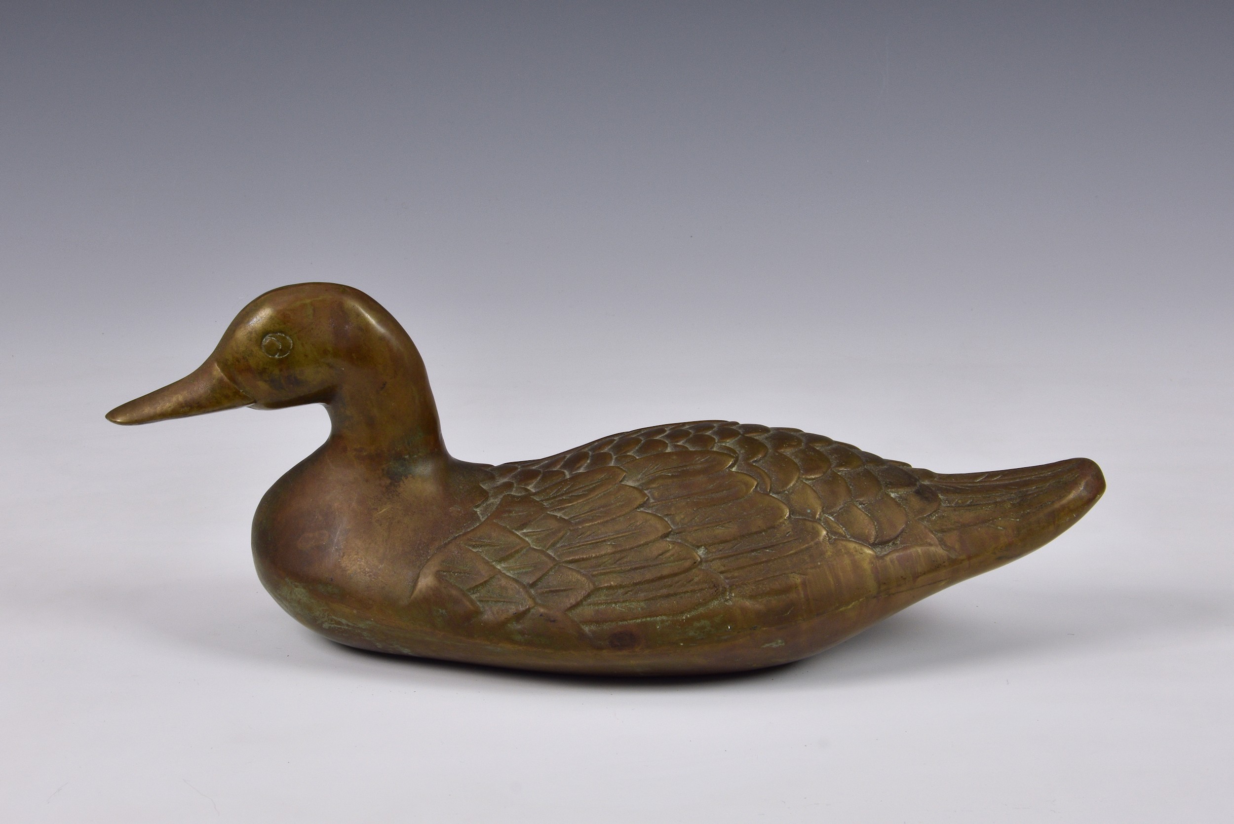 A Chinese bronze figure of a Duck, 14in. (35.6cm.) long. * Unmarked, gold/brown patina.