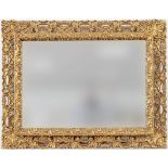 An early 19th century style giltwood mirror, late 20th century, the pierced frame carved with