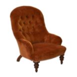 A Victorian low armchair or nursing chair, the buttoned back and arms over a serpentine seat,