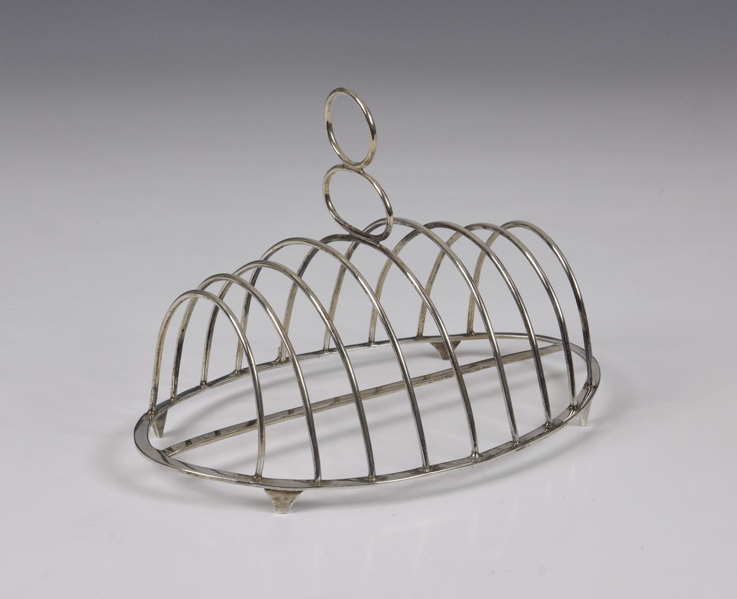 A George III silver toast rack, John Lambe, London, 1786, of oval form, nine plain wire-work bars,