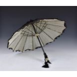 A 1920s parasol with white silk and black lace overlay, Art Deco style black plastic handle with