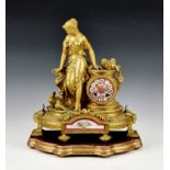 A French gilt metal and porcelain mantel clock, emblematic of Innocence, late 19th / early 20th