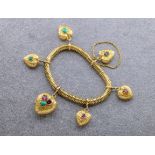 A Victorian flexible gold bracelet with gem set heart charms, set with 18ct and 15ct gold, each