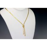 A 9ct yellow gold necklet, the flexible necklet with a crossover terminal set with a single