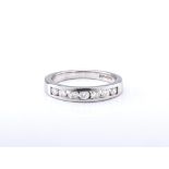 An 18ct white gold and diamond half eternity band, the channel set, brilliant cut diamonds totalling