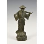 A Chinese bronze figure of a peasant, probably 20th century, on a lotus base, 9 ½in. (24cm.) high. *
