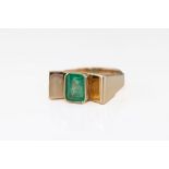 A 1970s 18ct yellow gold and emerald ring, the approx. 9 x 6.5mm. cut cornered rectangular emerald