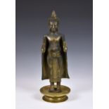 A gilt and black-lacquered figure of Buddha Shakyamuni, Thailand, cast metal Buddha, standing in