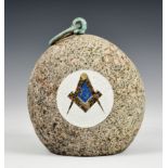 Freemasonry interest - A Jersey granite weight with brass ring handle, decorated with raised Masonic