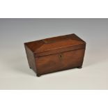 A Regency mahogany sarcophagus form tea caddy, the hinged cover, opening to reveal twin lidded