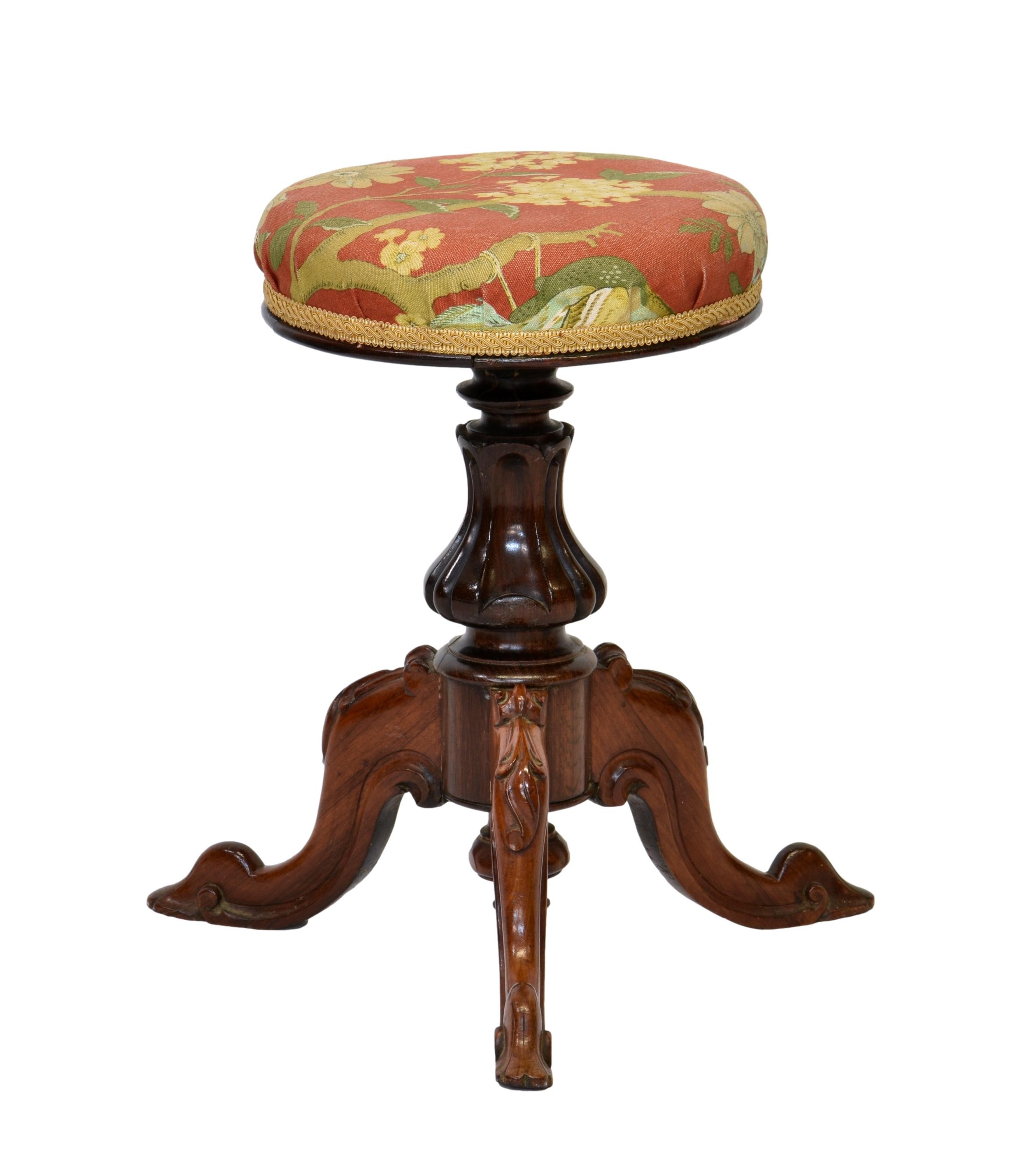 A Victorian carved rosewood adjustable piano stool, the circular stuff over seat on a lappet